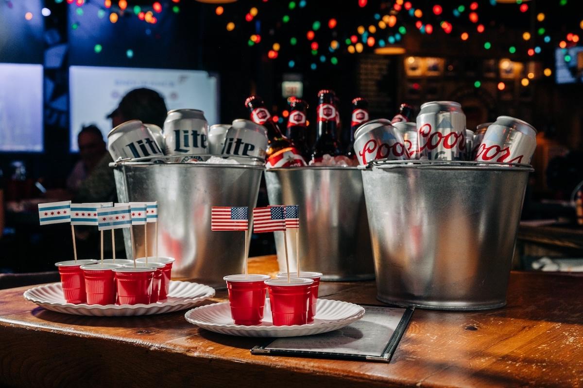 plates of jello shots in front of three buckets of beer