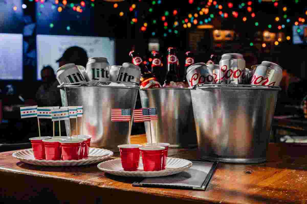 plates of jello shots in front of three buckets of beer