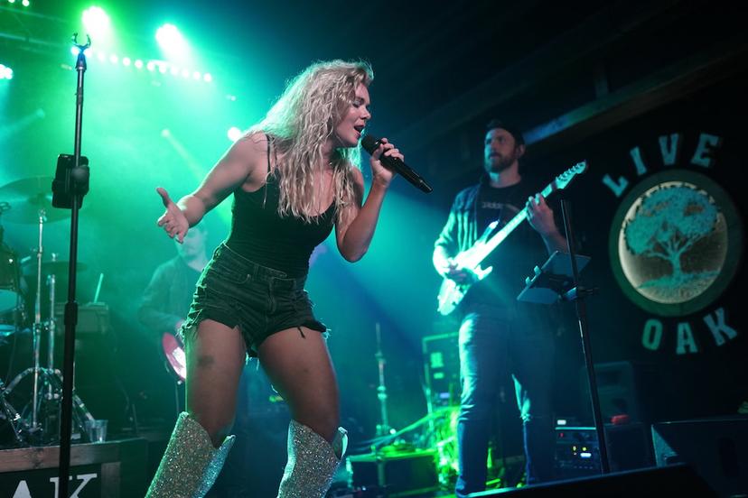 a crowd of people have their phones in their hands with the flashlight on and sing