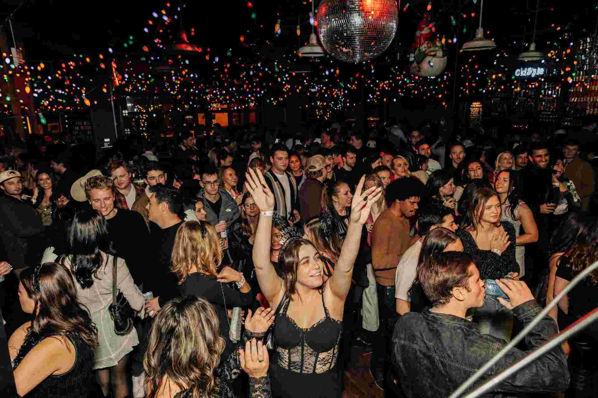 girl with her hands in the air in a crowd