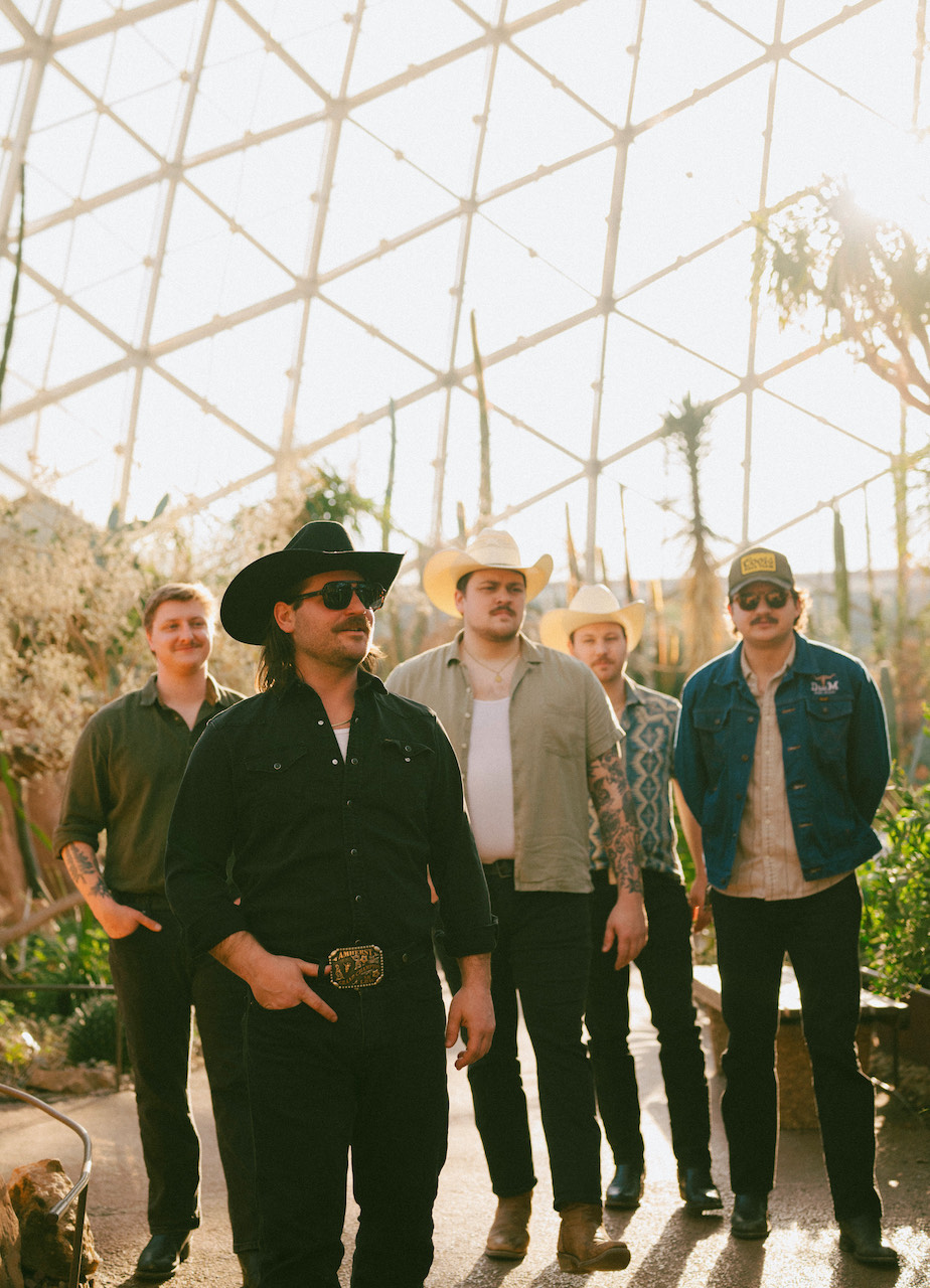 a crowd of people have their phones in their hands with the flashlight on and sing