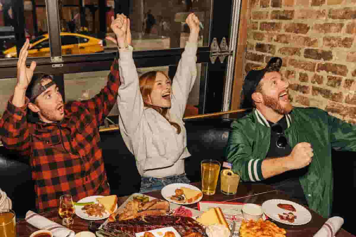 a group of three people cheersing