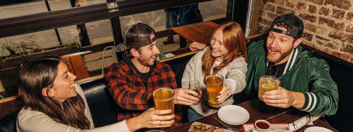 a group of four people cheersing