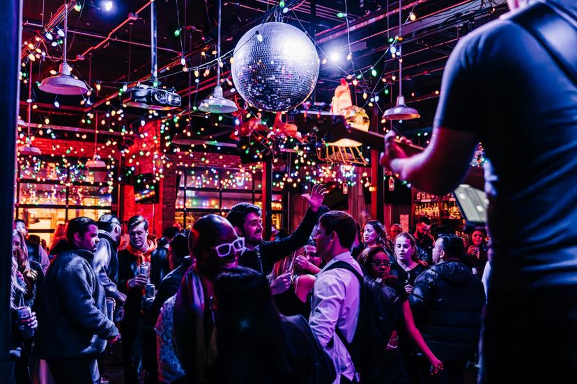 a crowd of people have their phones in their hands with the flashlight on and sing