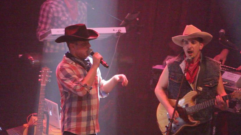 a crowd of people have their phones in their hands with the flashlight on and sing