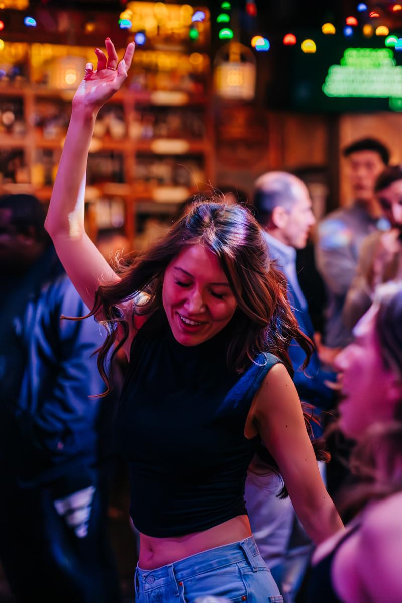 Girl dancing with her hand in the air.