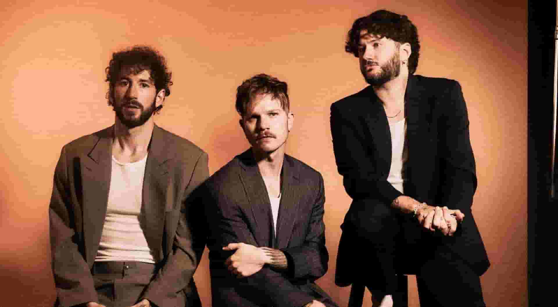 The three members of The Band CAMINO sitting on stools