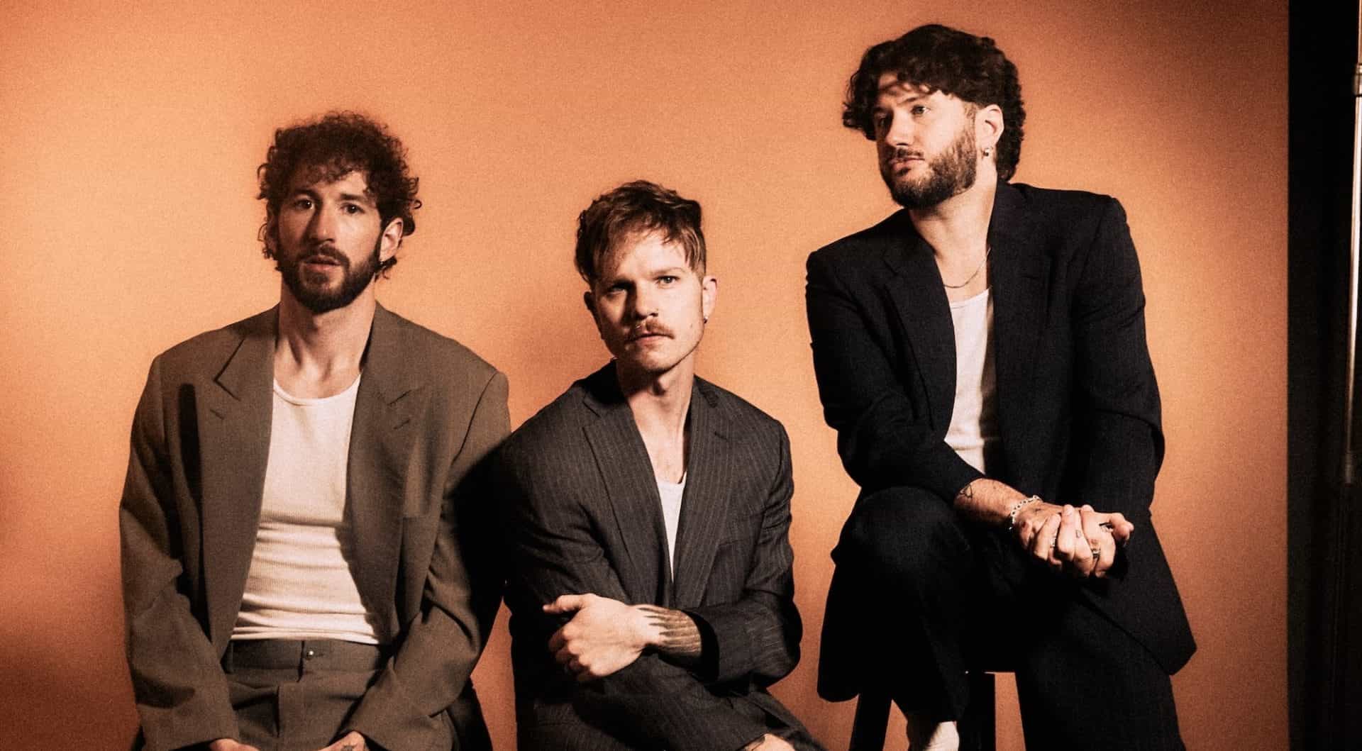 The three members of The Band CAMINO sitting on stools