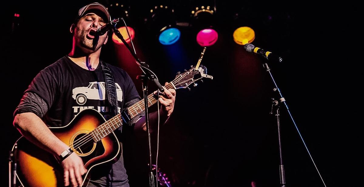 a crowd of people have their phones in their hands with the flashlight on and sing